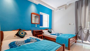 A hotel room with two beds, a window with blue shutters, a mirror, and a ceiling fan. - Poseidon Edge No9 by Rentalspro - Kallithea (Kassandra)
