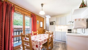 A kitchen with white cabinets, a microwave, and a coffee maker.