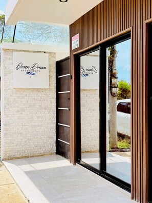 A building entrance with a sign for 'Ocean Dream Apartments I' and a warning sign about security cameras. - Ocean Dream Apartments E1-A1 (San Juan del Sur)