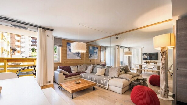 A modern living room with a sofa set, a coffee table, and a dining area. - Renovated apartment for 5 - with balcony (Megève)