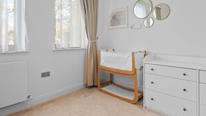 A child's room with a bunk bed, a white dresser, and a window with curtains. - London Road Apartment in Isleworth (Isleworth)
