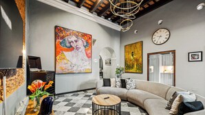 A modern living room with a checkered floor, a large sofa, a coffee table, and a painting on the wall. - Old San Juan Pool House & Jacuzzi Grotto (San Juan)