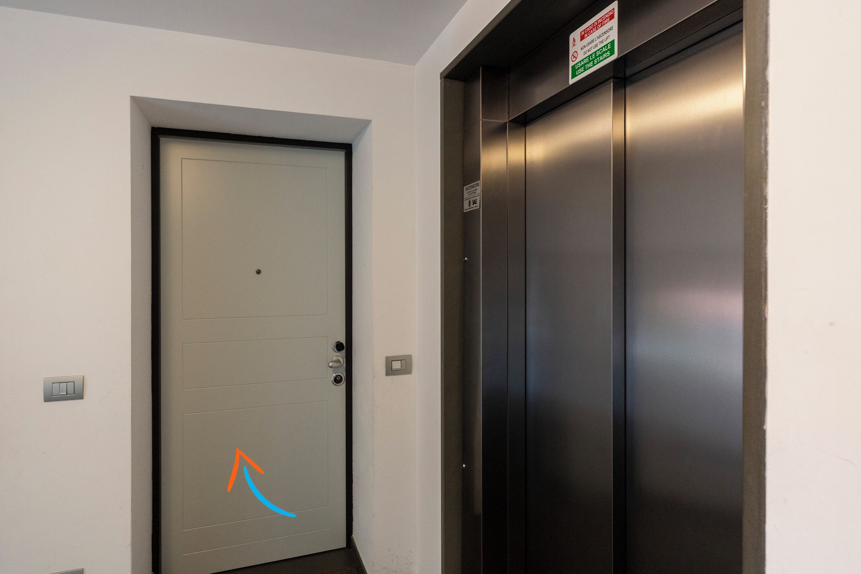 An elevator and a door with a sign indicating the elevator is out of service.