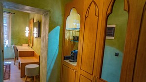 A room with a wooden wardrobe, a desk, and a chair. - Fabrizio del Carretto (Rhodes)