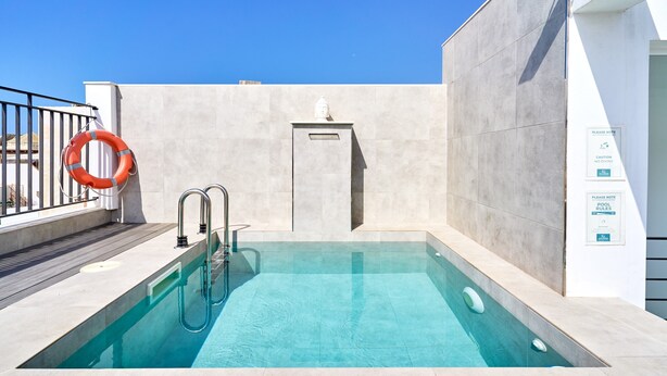 A swimming pool with a lifebuoy, a metal ladder, and a wall-mounted plaque. - Holiday Home 'Casa Tita Mercedes' with Private Pool, Wi-Fi and Air Conditioning (Nerja)