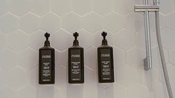 Three Gilchrist & Soames products on a white hexagonal tile wall.