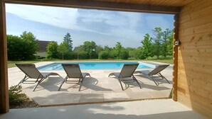 A wooden deck with a pool and lounge chairs. - Guest Room 'Carmin' with Shared Pool, Shared Terrace and Wi-Fi (Beaumont sur Grosne)