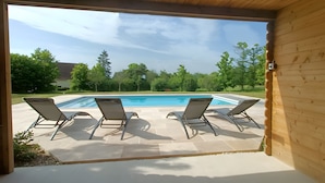 A wooden deck with a pool and lounge chairs. - Guest Room 'Tilleul' with Shared Pool, Shared Terrace and Wi-Fi (Beaumont sur Grosne)