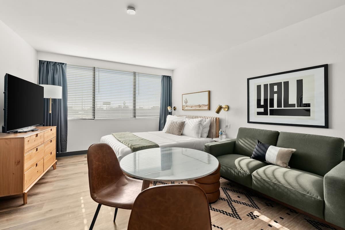 Signature Studio Suite, 1 Queen Bed, Kitchenette | Desk, laptop workspace, blackout drapes, iron/ironing board