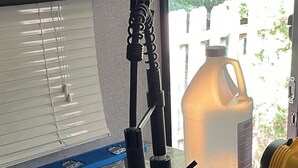 A kitchen counter with a sink, a large water jug, and a power tool. -  Coleman camper you can pick it up and take it to your favorite campground (Berrien Springs)