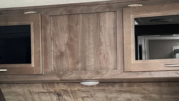 A bedroom with a wooden headboard, a bed with white bedding, and a small window. -  Coleman camper you can pick it up and take it to your favorite campground (Berrien Springs)