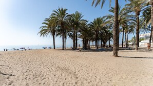 A sandy beach with palm trees and a clear sky. - MalagaSuite Sky & Sea Torremolinos (Torremolinos)