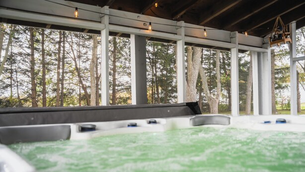 A hot tub area with a view of trees through a covered structure. - Pinch of Cozy ~ Hot Tub Theater ~ Seven Sons Farm (Roanoke)