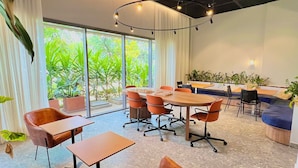 A modern conference room with a large table, leather chairs, and potted plants. - AD 330 (São Paulo)