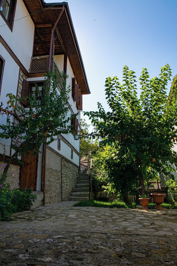 A traditional building with a stone staircase leading to a wooden door.