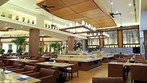 A spacious hotel lobby with multiple dining areas, large pillars, and ceiling fans. - Tiantai Yunjie International Hotel (Xiuwu)