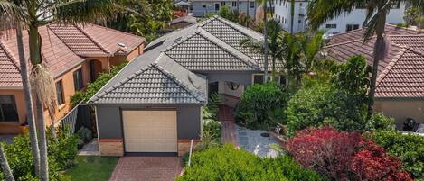 A residential area with houses featuring red-tiled roofs and a central garage.