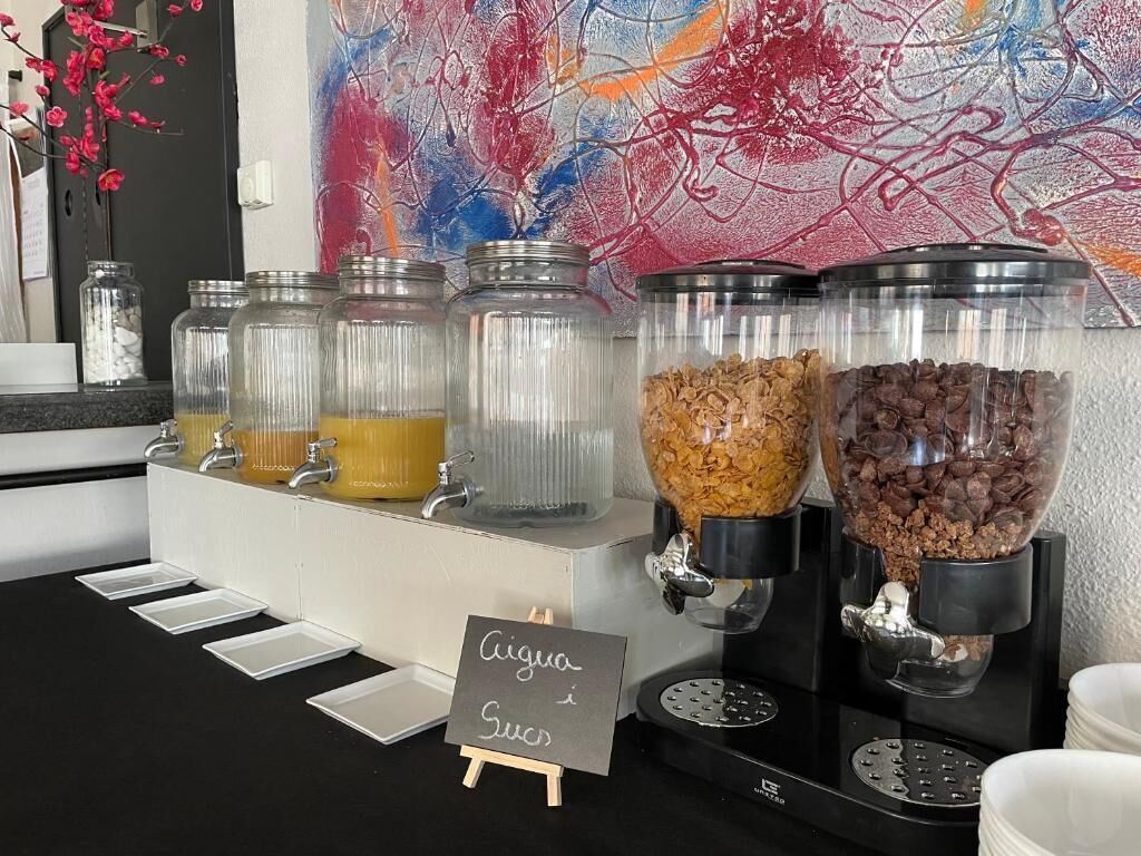 A coffee station with multiple dispensers, each containing different types of coffee and creamer options.