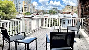 A wooden deck with a white railing, two black chairs, and a table. - LUXURIOUS DC ESTATE, BEST LOCATION BLOCK AWAY FROM 14TH/U ST NW W/ 2 CAR PARKING (Washington)