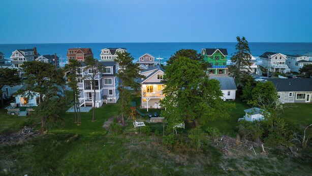 A coastal residential area with houses, some with visible decks and a few with visible porches.
