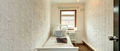 Light-filled and spacious single bedroom with a chest of drawers for storage and blackout blinds for a comfortable night’s rest.