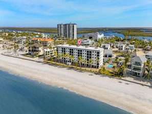 A beachfront hotel with a central building, a pool, and a beach view. - Seaside 3 by Distinctive Beach Rentals (Fort Myers Beach)