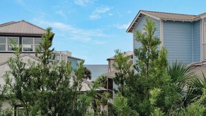 A coastal residential area with houses featuring gabled roofs and light blue siding. - 4BR Home w/ Private Pool, Game Room, Beach Access! (Santa Rosa Beach)