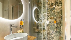 A bathroom with a large oval sink, a mirror with a circular light, and a shower with a glass door. - Elegant Double Room in the Heart of the Peaceful Colli Albani Area (ROMA)
