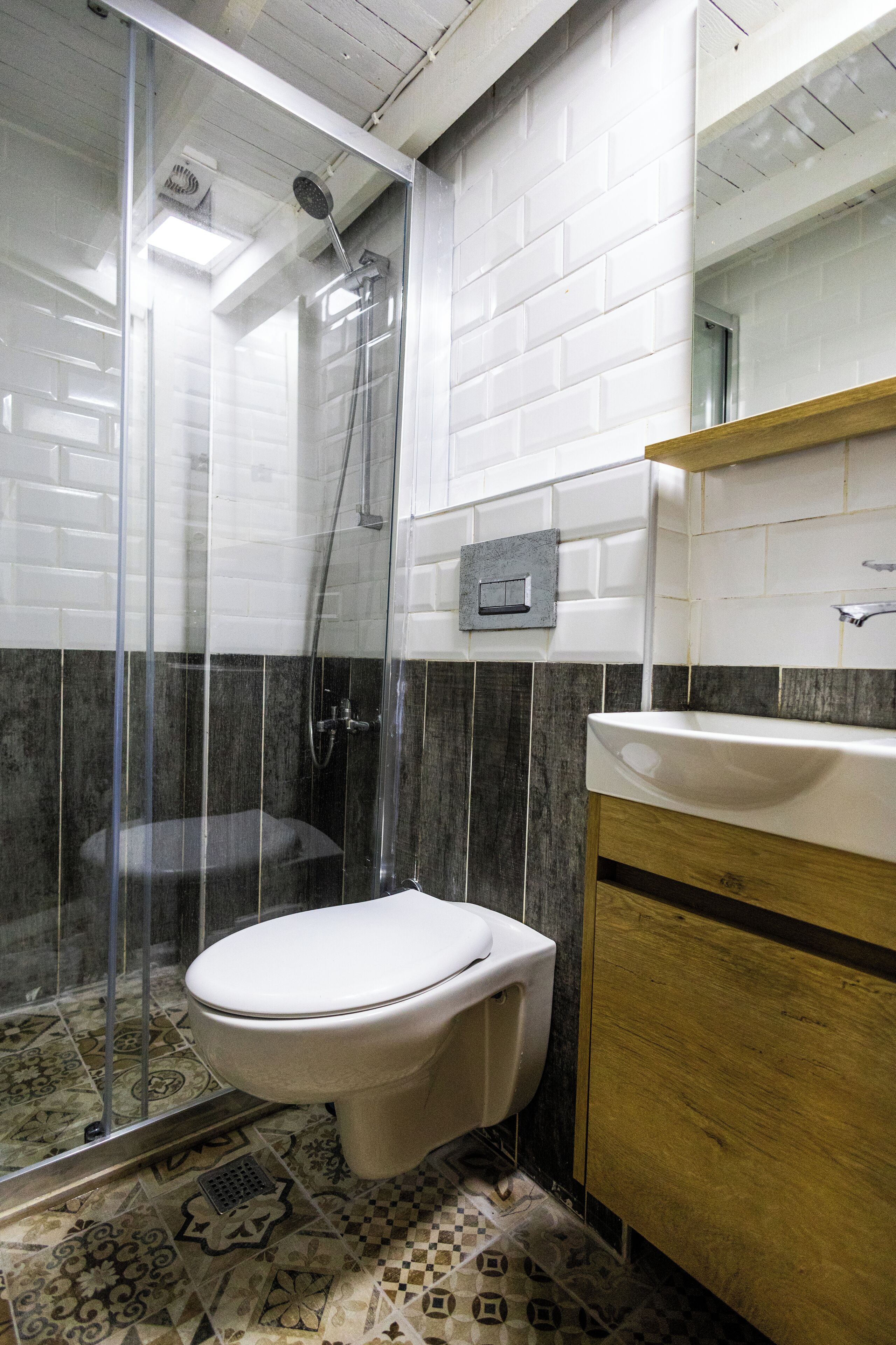 A bathroom with a shower, toilet, and sink.