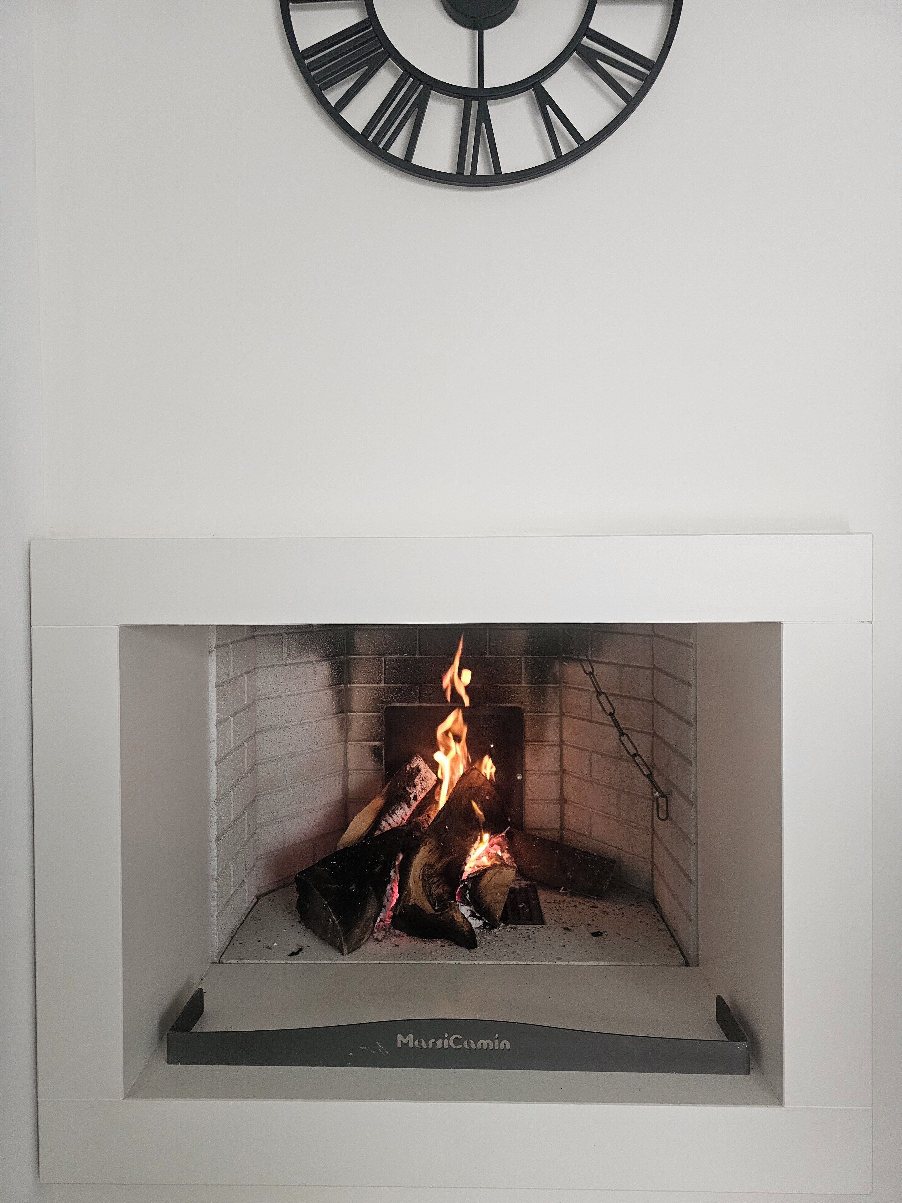 A fireplace with a clock above it.