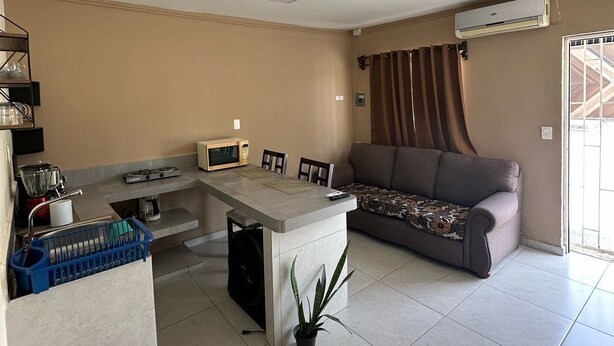 A compact living space with a kitchenette, dining area, and a sofa. - Complete apartment in the port of Veracruz, ideal for relaxing! (Veracruz)