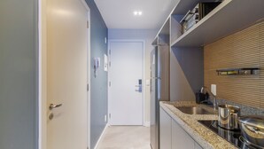 A modern kitchen with a built-in oven, stainless steel appliances, and a granite countertop. - La Vida (São Paulo)