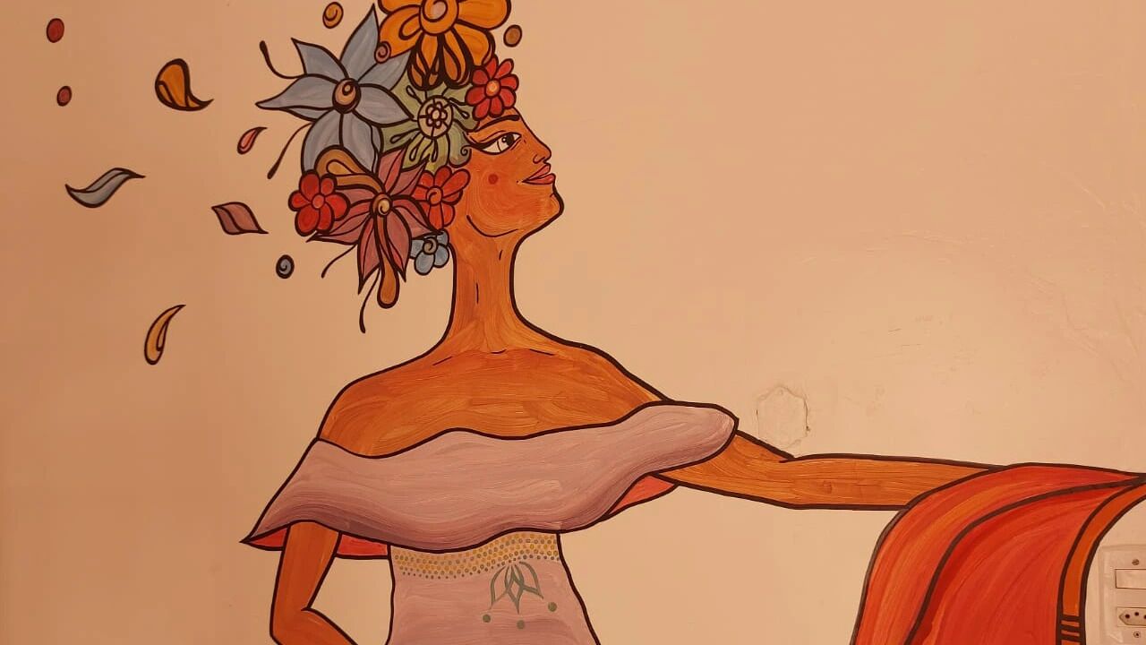A person with a floral headpiece and a flowing garment.