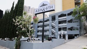 A hotel sign for "ASH&9TH" with a modern building in the background. - Ash&9th (San Diego)