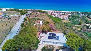 Vista aérea de una zona costera con carretera, edificios y playa.
