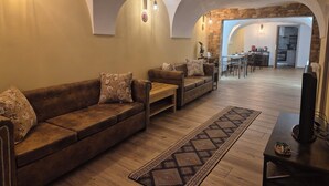 A spacious living area with a sofa, a coffee table, and a patterned rug.