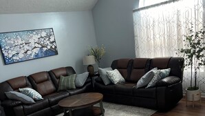 A modern living room with a sectional sofa, a coffee table, and a painting on the wall. - Prime Location! 3BR/2BA house near [National Hills] in beautiful Augusta! (Augusta)