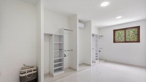 A spacious, well-lit room with white walls and a large window. - Senderos De Ciudad Mayakoba (Playa del Carmen)