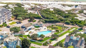 A resort with a swimming pool, beach access, and a variety of buildings.