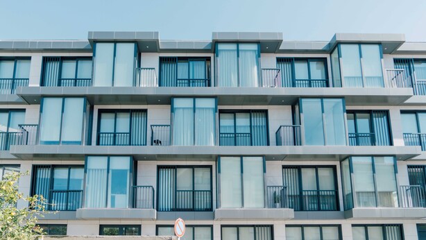 A multi-story hotel with a modern architectural design, featuring balconies with railings and large windows. - Oporto Yellow Apartments104 (Porto)