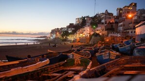 Boats on a beach with buildings in the background. - Best room with WiFi in taghazout (agadir)
