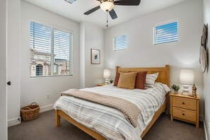 A bedroom with a bed, nightstands, a ceiling fan, and windows. - Paseos Retreat: 2 Luxury Homes w/ Pool, Hot Tubs, Game Rooms, & Resort Access (Washington)