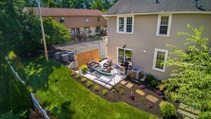 A residential backyard with a patio, outdoor furniture, and a small garden. - Walk to Uptown Westerville, Luxe Historic Charm (Westerville)