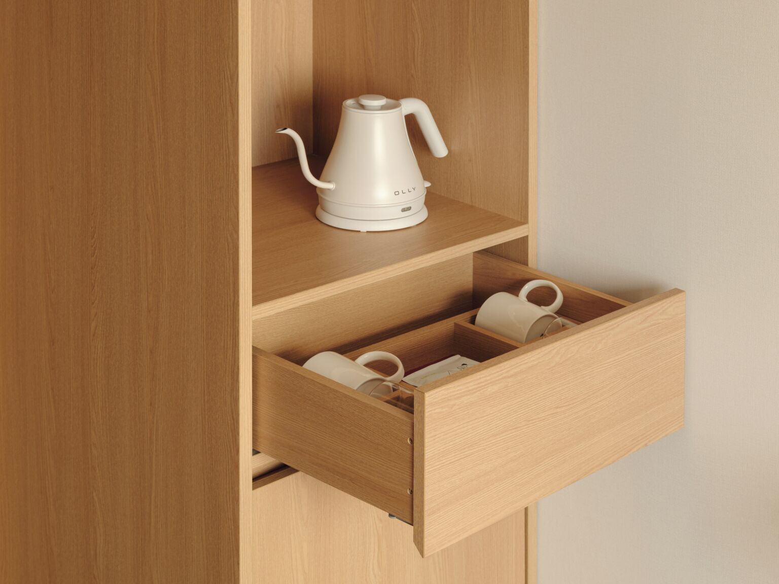 A wooden cabinet with a white kettle on top and a drawer containing two white mugs.