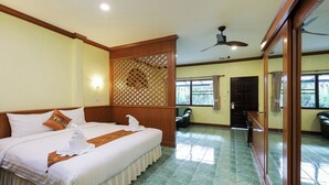 A hotel room with a large bed, a wooden partition, a ceiling fan, and a view of the outdoors. - The Gold-Digger's Resort (Sa Khu)