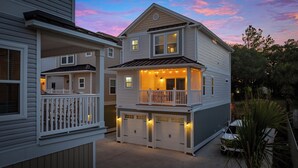A two-story house with a balcony and attached garage.