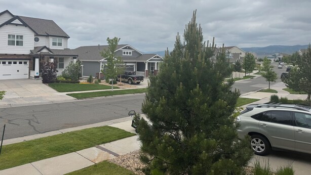 A suburban neighborhood with houses, a driveway, and a car. - Relaxing Arvada Escape Between Golden & Boulder (Arvada)