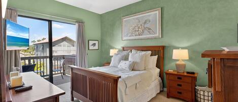 A bedroom with a bed, a desk, a chair, a nightstand, a lamp, a ceiling fan, and a painting.