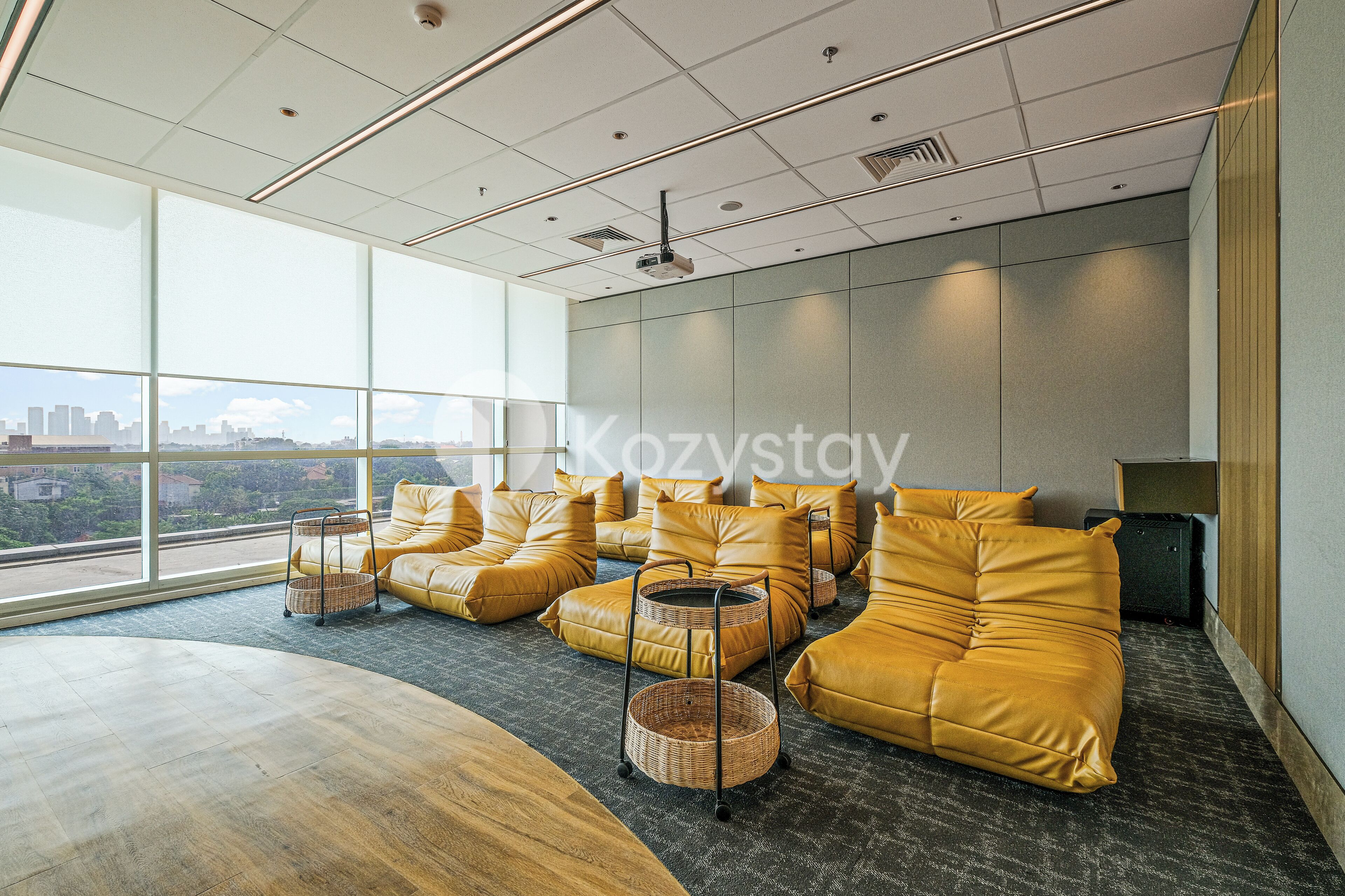 A modern lounge area with leather sofas, a wooden table, and a large window offering a city view.
