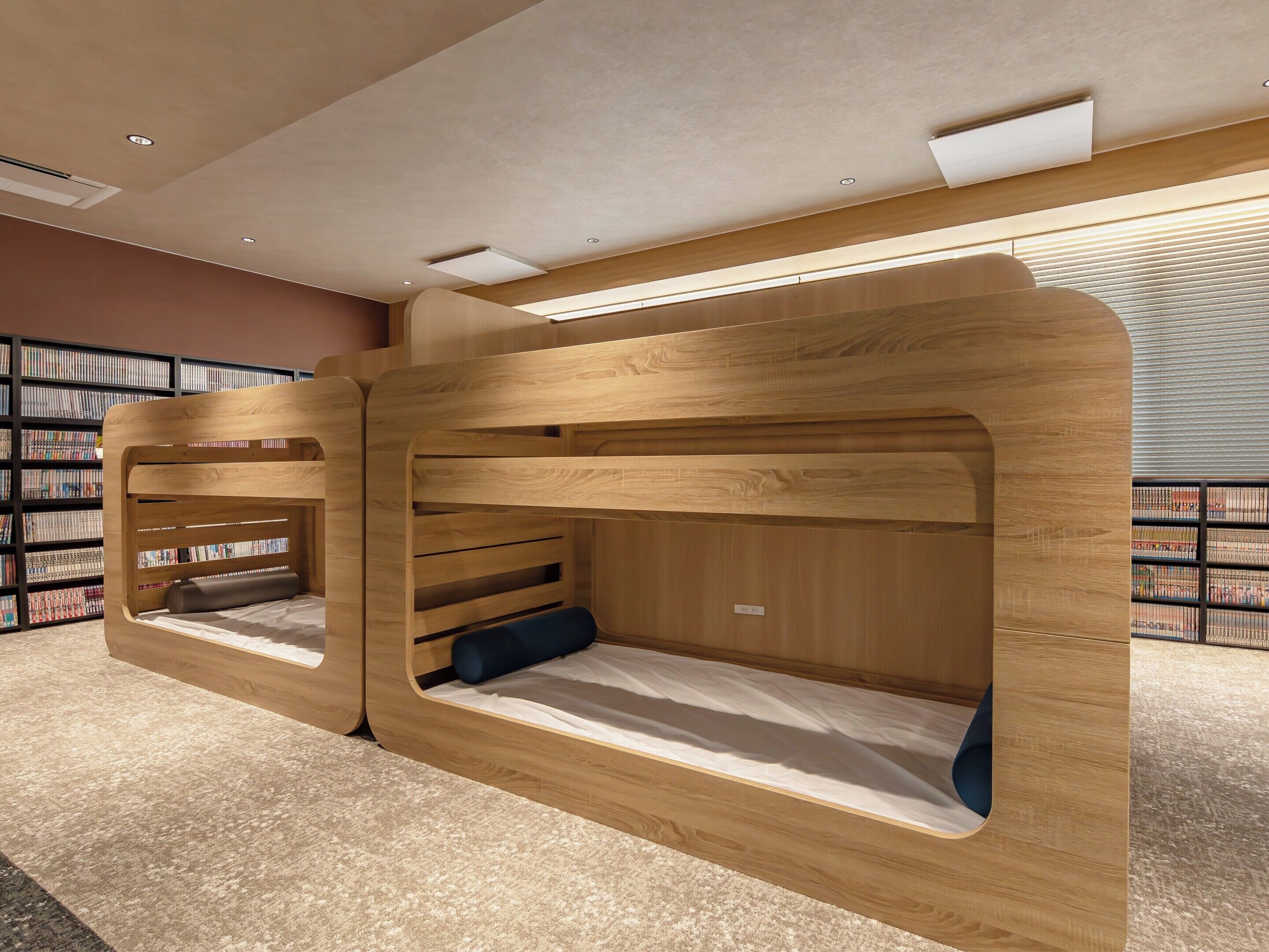 A library with wooden reading nooks and bookshelves.